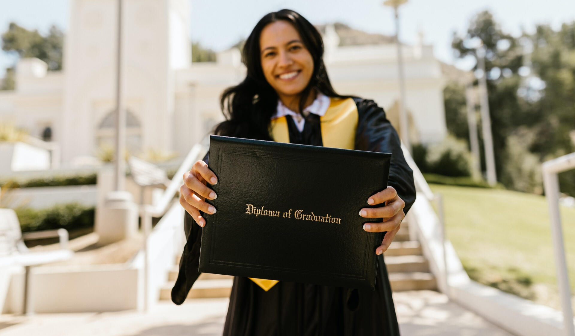 Graduate showing diploma